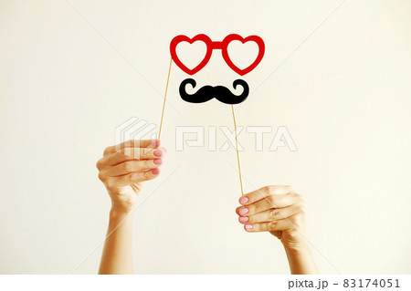 Paper party attributes in form of moustache on wooden stick. Carnival accessory concept. 83174051