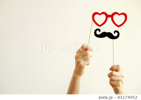 Paper party attributes in form of moustache on wooden stick. Carnival accessory concept. 83174052