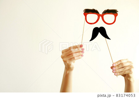 Paper party attributes in form of moustache on wooden stick. Carnival accessory concept. 83174053
