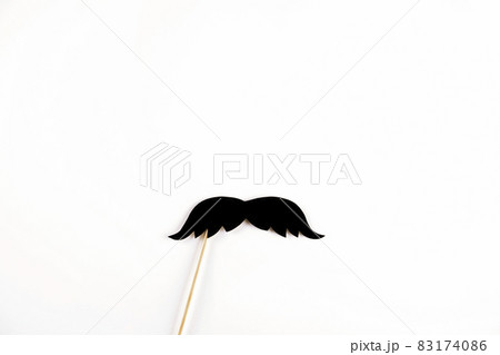 Paper party attributes in form of mustache on wooden stick. Carnival accessory concept. 83174086