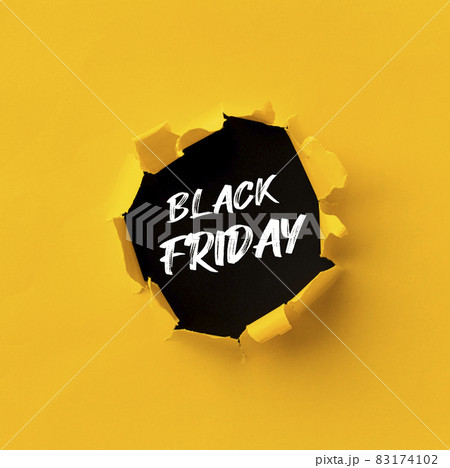 Black Friday text in paper hole teared in yellow paper over black background Black Friday text in paper hole teared in yellow paper over black background 83174102