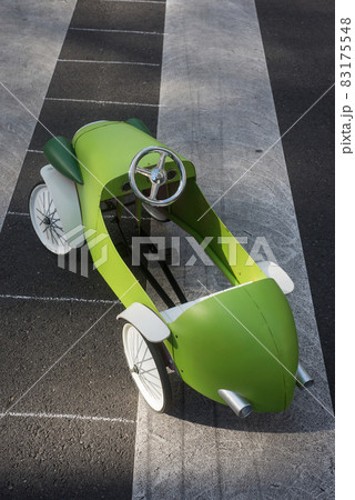 Closeup of wooden vintage car for children parked in the street Closeup of wooden vintage car for children parked in the street 83175548