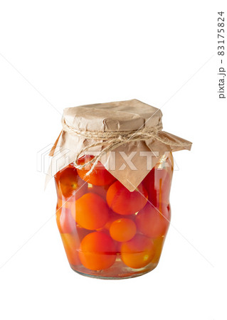 Pickled tomatoes in a glass jar isolated on a white background. Fermented trending food. Homemade preserves. Pickled tomatoes in a glass jar isolated on a white background. Fermented trending food. Homemade preserves. 83175824