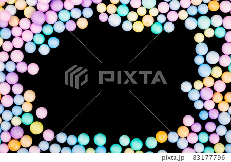 Foam beads of various colors brightly colored on black background. 83177796