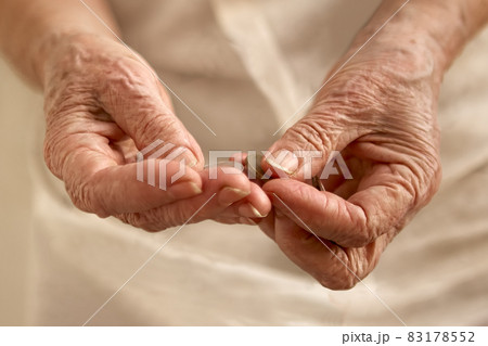 Old woman's wrinkled hands counting small coins 83178552