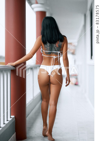 Asian young sexy girl in white lingerie standing at the balcony 83178575