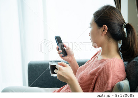 Woman resting in living room. 83180088