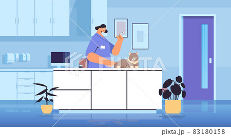female veterinarian giving vaccine to cat at vet clinic pet vaccination concept horizontal 83180158