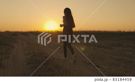 girl running at sunset on the field, morning jogging of healthy lifestyle at dawn, cardio load increasing heart rate, time to dream, fitness training generation z, triathlon marathon treadmill runner girl running at sunset on the field, morning jogging of healthy lifestyle at dawn, cardio load increasing heart rate, time to dream, fitness training generation z, triathlon marathon treadmill runner 83184459