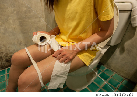Cropped shot of woman sitting on toilet bowl, she suffering from Diarrhea or Stomach ache. Privacy time in toilet. Cropped shot of woman sitting on toilet bowl, she suffering from Diarrhea or Stomach ache. Privacy time in toilet. 83185239