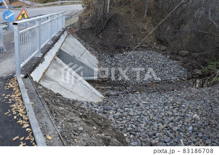 Automobile and pedestrian small bridge over a small river. Automobile and pedestrian small bridge over a small river. 83186708