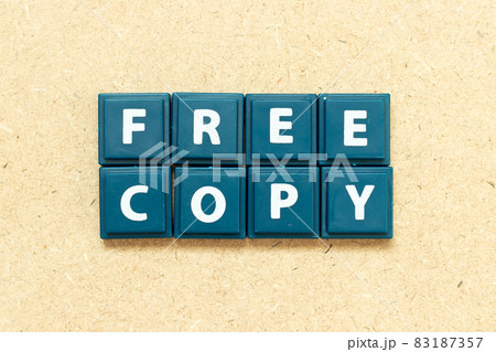 Tile alphabet letter in word free copy on wood background 83187357