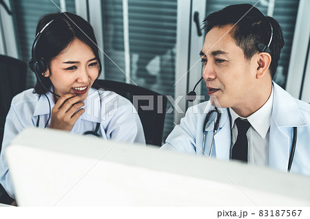 Doctor team wearing headset talking actively on video call in hospital clinic 83187567