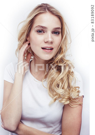 young pretty stylish blond hipster girl posing emotional isolated on white background happy smiling cool smile, lifestyle people concept 83189092