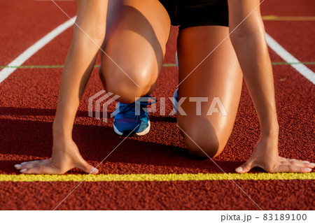 Close-up of woman's legs on start before jogging Close-up of woman's legs on start before jogging 83189100