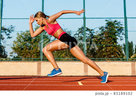 Runner sprinting towards success on run path running athletic track. Goal achievement concept. Runner sprinting towards success on run path running athletic track. Goal achievement concept. 83189102