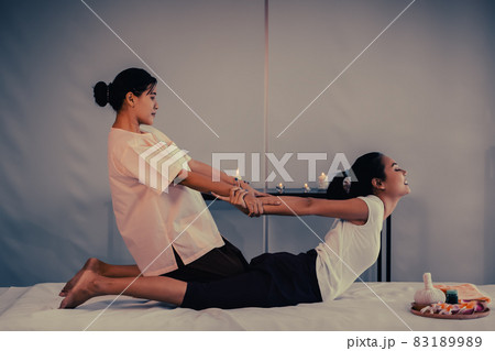 Massage Therapist is giving Asian woman a Back Stretching in a Thai Massage Spa treatment Massage Therapist is giving Asian woman a Back Stretching in a Thai Massage Spa treatment 83189989