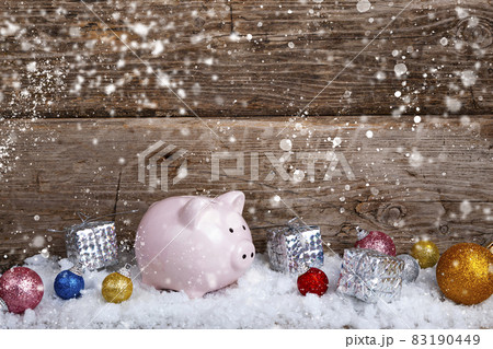 Pig piggy bank and Christmas balls in the snow Pig piggy bank and Christmas balls in the snow 83190449
