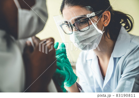 Young man visits skillful doctor at hospital for vaccination 83190811