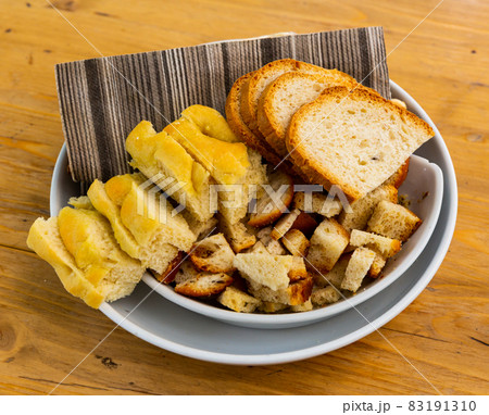 Italian bread, croutons, grissini on plate Italian bread, croutons, grissini on plate 83191310