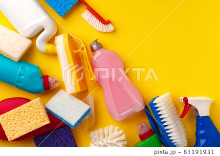 Set of cleaning supplies on yellow color background Set of cleaning supplies on yellow color background 83191931