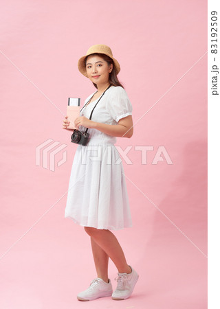 attractive young female happy ready to go on vacation, isolated on white background 83192509