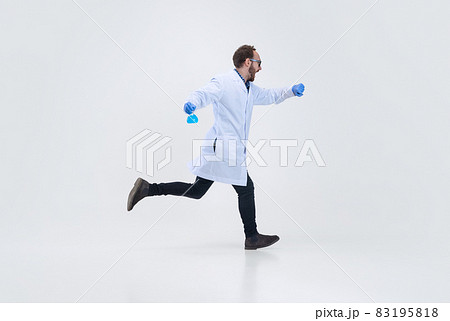 Portrait of running man, chemist, doctor in action and motion isolated on white background. Concept of healthcare, pharmaceuticals, medicine 83195818
