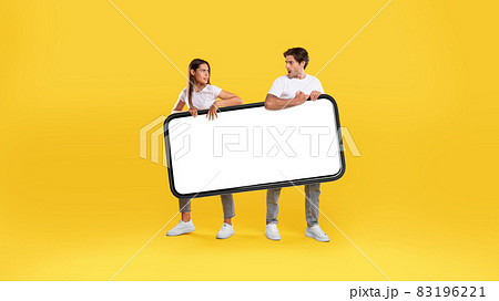 Couple holding big white empty smartphone screen 83196221