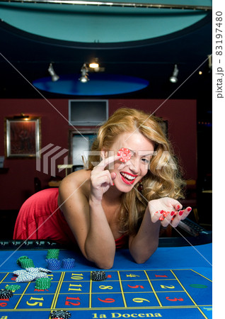 attractive woman in red playing on a casino table attractive woman in red playing on a casino table 83197480