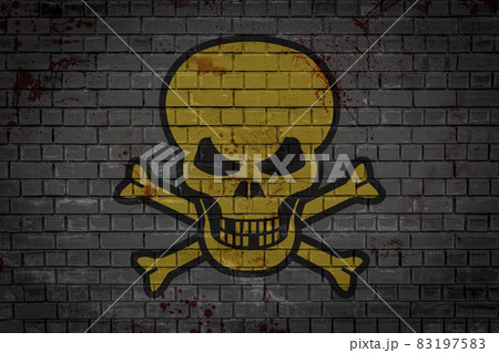 Yellow skull pictured on a gray brick wall Yellow skull pictured on a gray brick wall 83197583