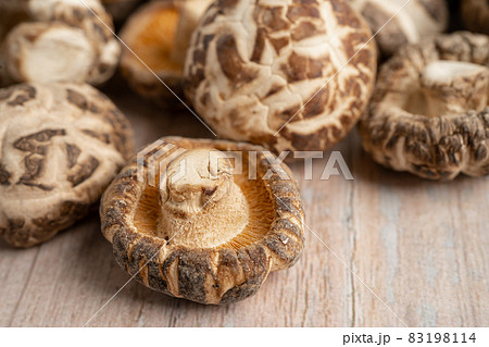Dried shiitake mushroom on wooden background. Healthy food. 83198114