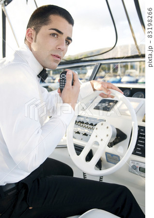 young elegant man at yacht control . young elegant man at yacht control . 83198266