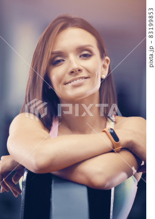 Portrait of young brown-haired woman outdoor at sport playground. Caucasian fitness girl during workout. Sport and health care concept Portrait of young brown-haired woman outdoor at sport playground. Caucasian fitness girl during workout. Sport and health care concept 83199853