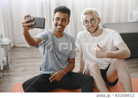 Two male friends taking selfie after home workout 83200612