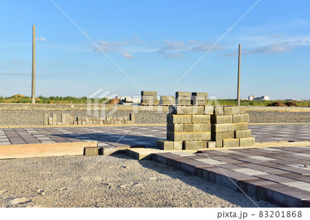 Laying paving slabs at construction site. Laying paving slabs at construction site. 83201868