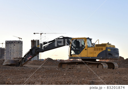 Excavator on earthworks at construction site.  83201874