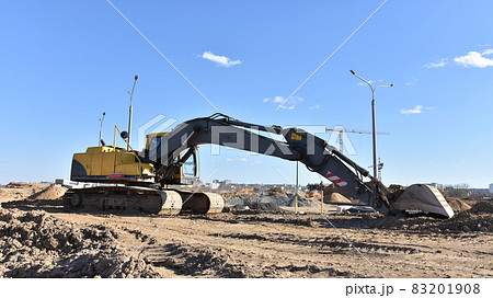 Excavator during earthmoving work at construction site. 83201908