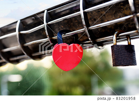 Padlock on Lovers Lock Bridge. Husband and wife during the wedding hung a padlock Padlock on Lovers Lock Bridge. Husband and wife during the wedding hung a padlock 83201958