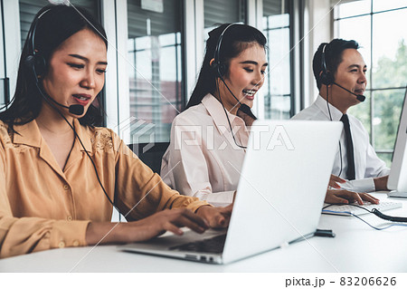 Business people wearing headset working actively in office Business people wearing headset working actively in office 83206626