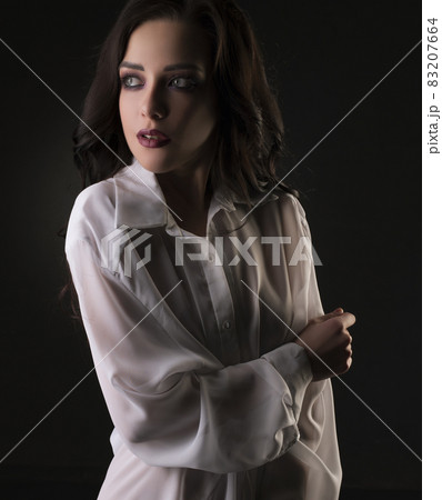 Sexy brunette in shirt cropped view in dark room Sexy brunette in shirt cropped view in dark room 83207664