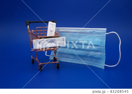 Covid-19 and shopping concept with mask, cart and tests 83208545