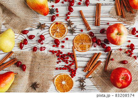 Berries and spices for mulled wine cooking close up on kitchen table 83208574