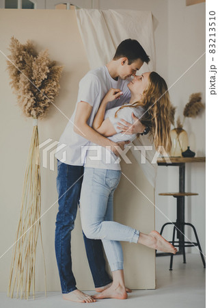 Portrait of young attractive romantic couple hugging and kissing on the background of pampas grass. Love and relationships lifestyle. Portrait of young attractive romantic couple hugging and kissing on the background of pampas grass. Love and relationships lifestyle. 83213510