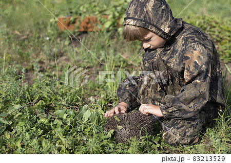 little boy touches and tries to open hedgehog 83213529