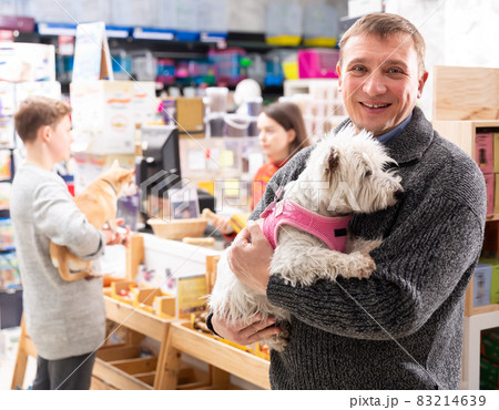 Man with west highland terrier dog 83214639