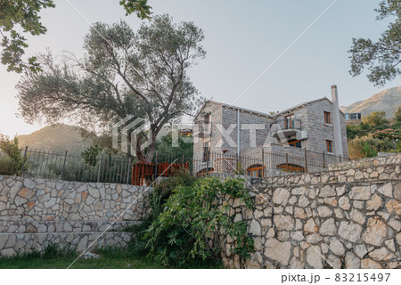 Beautiful villa in Mediterranean style with plants at sunset 83215497