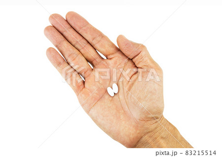 White pills on hand on white background with clipping path White pills on hand on white background with clipping path 83215514