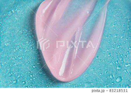 Liquid gel cosmetic product on blue background with drops. Texture and background. Texture and blurred effect Liquid gel cosmetic product on blue background with drops. Texture and background. Texture and blurred effect 83218531