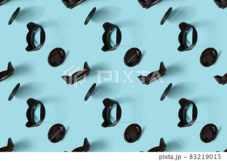 A pattern of photo accessories - lens caps and lens hoods. 83219015