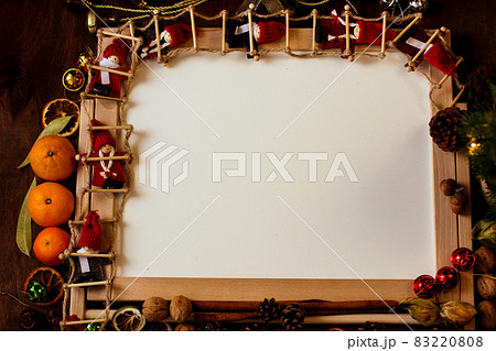 Christmas mockup. In the center is a white table in a wooden framed, around the Christmas decor. 83220808